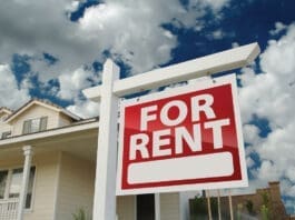Red And White For Rent Sign In Front Of House