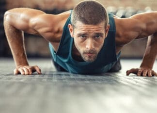 Determined Man Doing Push Ups At The Gym
